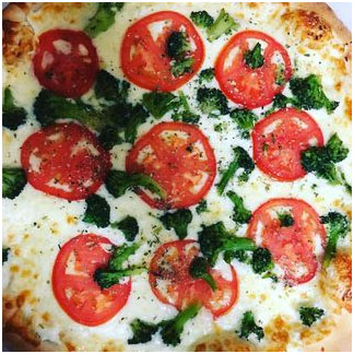 White pizza with broccoli and tomato